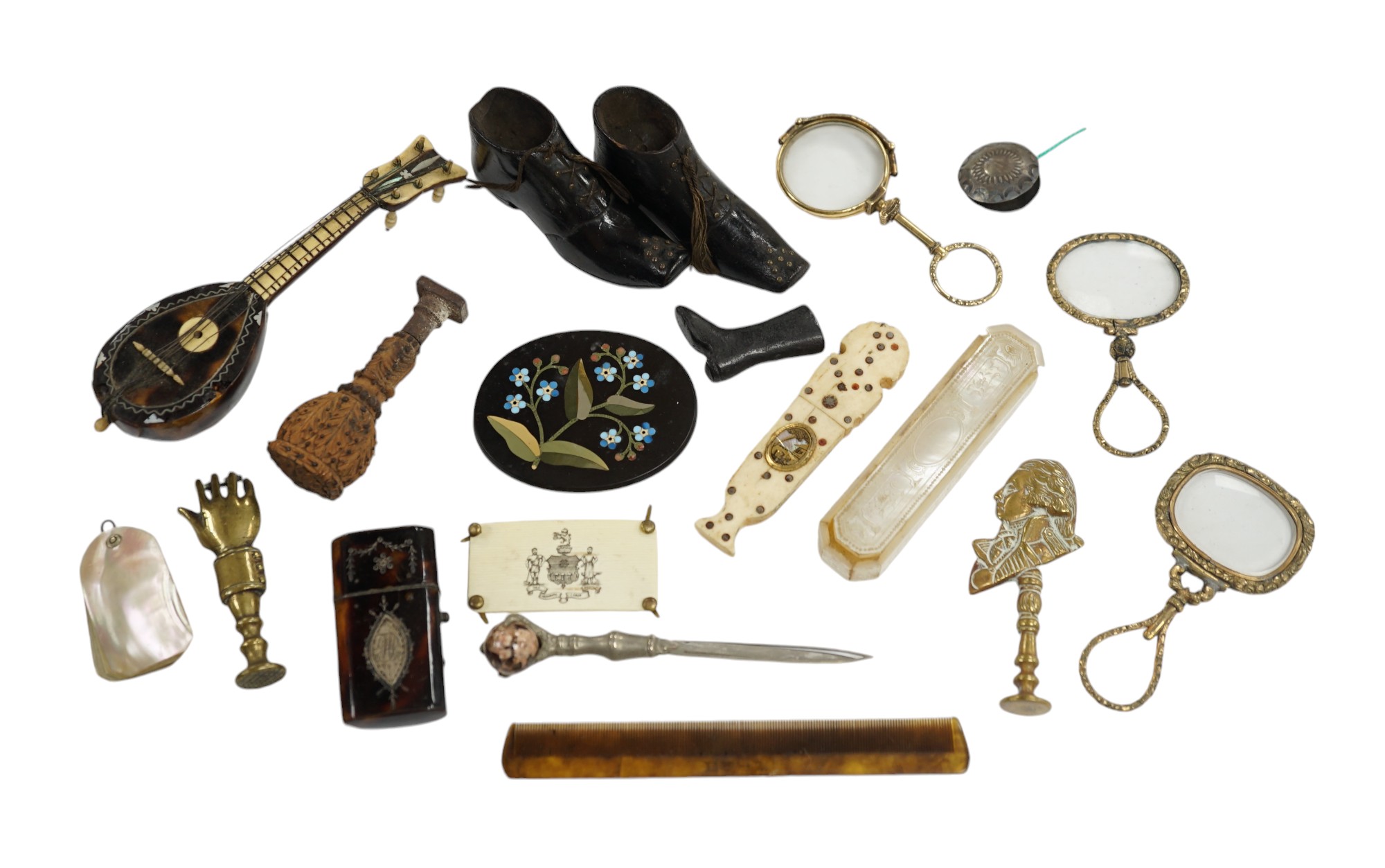 Miscellaneous objects of vertu including a pair of carved wood boots, an inlaid tortoiseshell needle case, a carved mother of pearl box and a pietra dura oval floral panel, largest 12.5cm in length. Condition - mostly fa